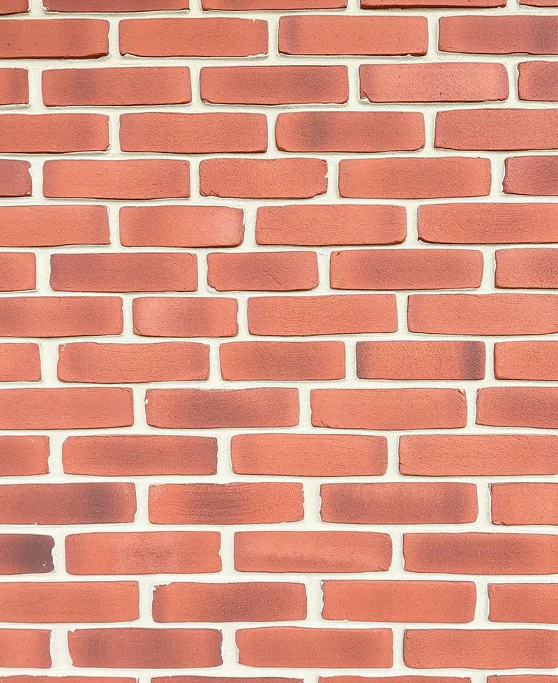 Restored red brick wall with fresh tuckpointed mortar joints in Allen, TX