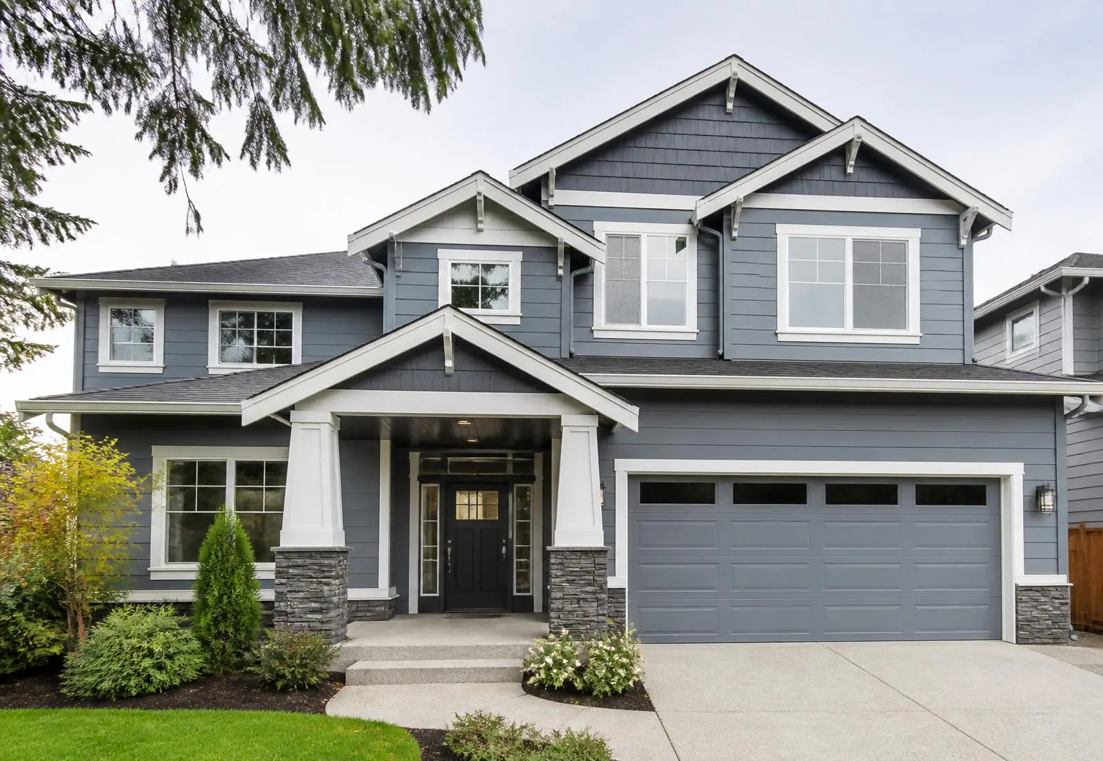 Craftsman home in McKinney, TX with new blue-gray siding and white trim installed by Blue Collar Exteriors